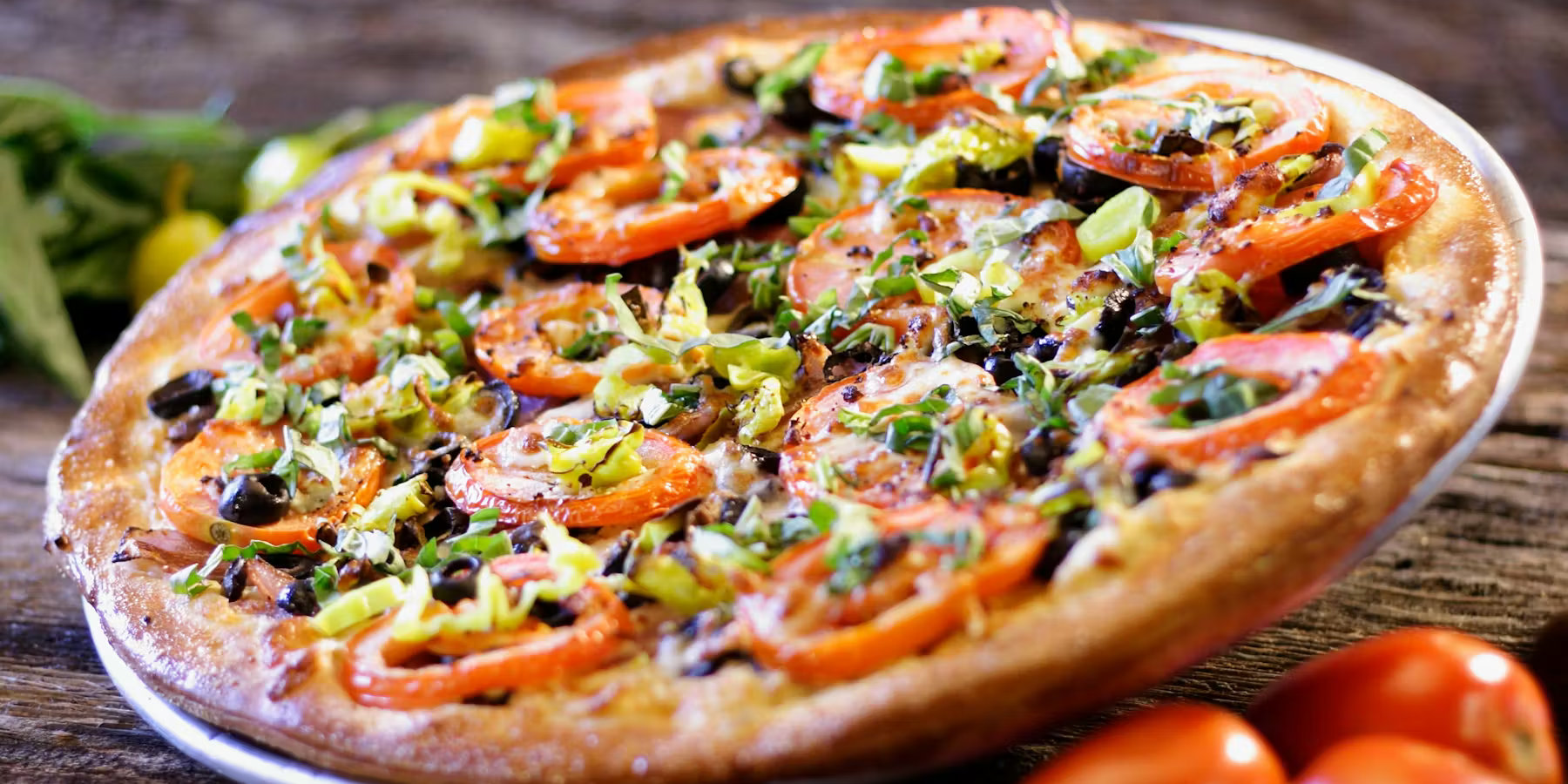 Peace in the Middle East pizza — hummus base, tomatoes, olives, feta, basil